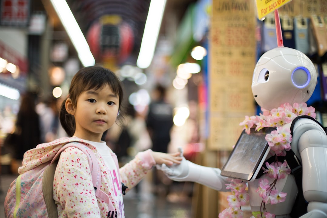 mission-img As Kuromon Market in Osaka was about to close for the evening I sampled some delicious king crab and did a final lap of the market when I stumbled upon one of the most Japanese scenes I could possibly imagine, a little girl, making friends with a robot.