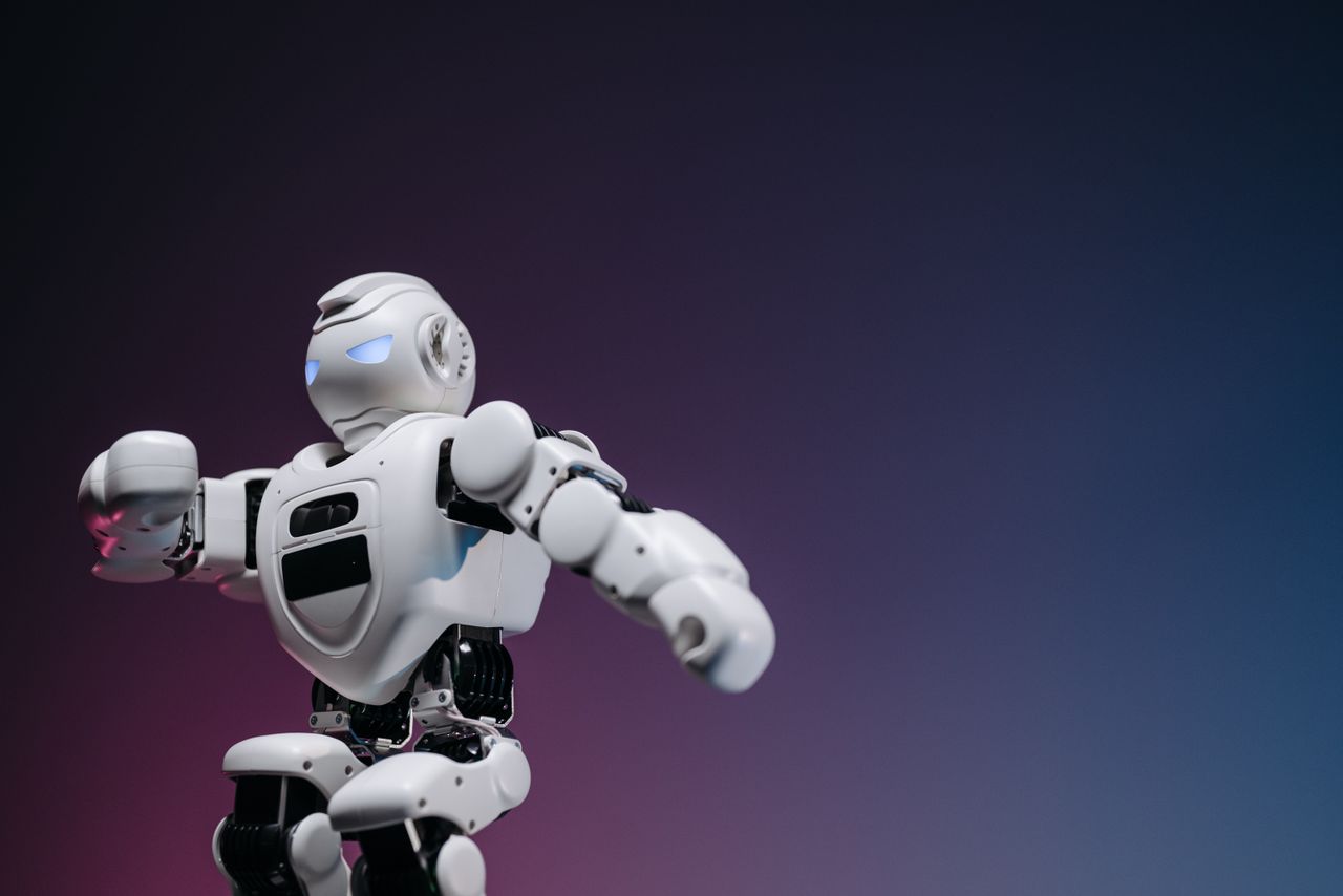 Close-up of a futuristic robotic toy against a gradient background, symbolizing innovation and technology.